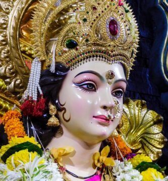 gold and white hindu deity figurine